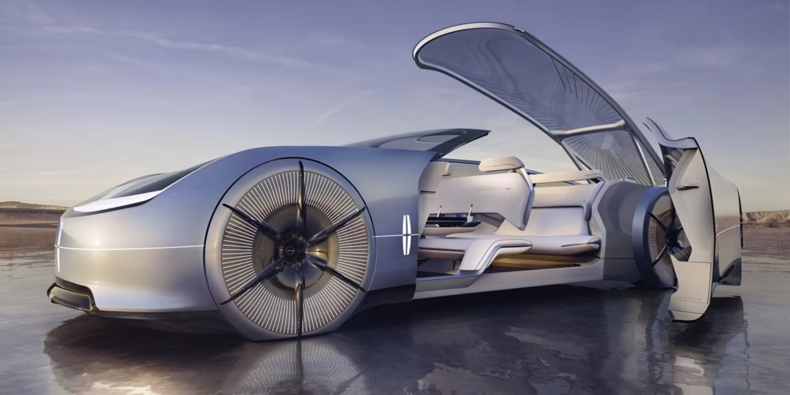 A silver vehicle with large, wing-like doors and a sleek, aerodynamic design on a wet, reflective surface against a hazy, blue sky background.