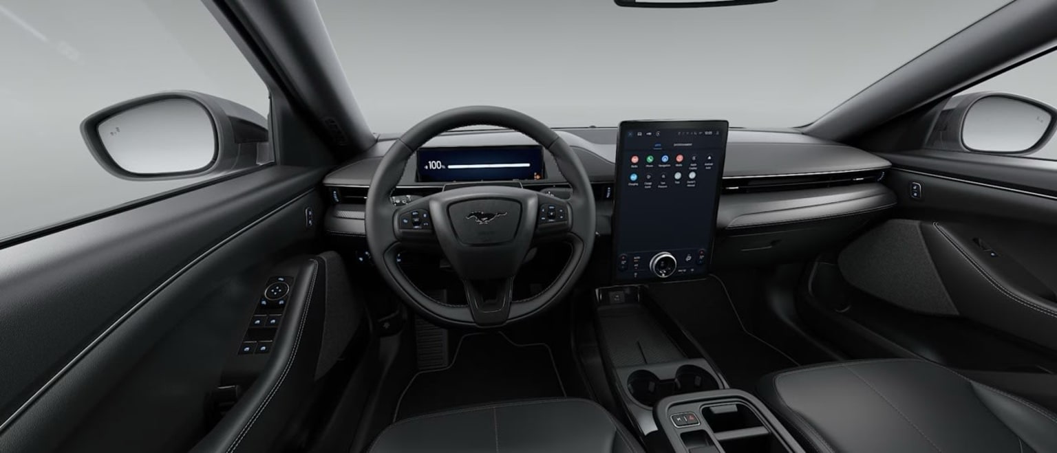 Interior of a modern vehicle with a sleek and minimalist dashboard design featuring a large touchscreen display, steering wheel, and various controls.