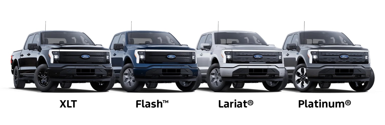 Four pickup trucks in various models and colors are displayed in the image. The trucks appear to be parked in a row, showcasing their distinct designs and features.