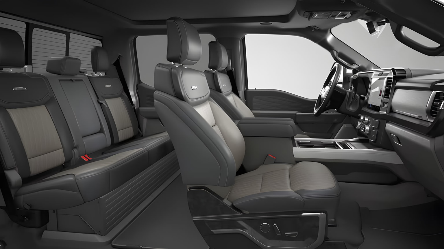Interior of a spacious vehicle with comfortable-looking leather seats, center console, and a large windshield.