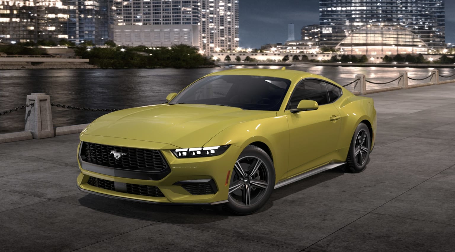 A bright yellow sports car parked on a waterfront promenade, with a modern city skyline and illuminated buildings in the background.