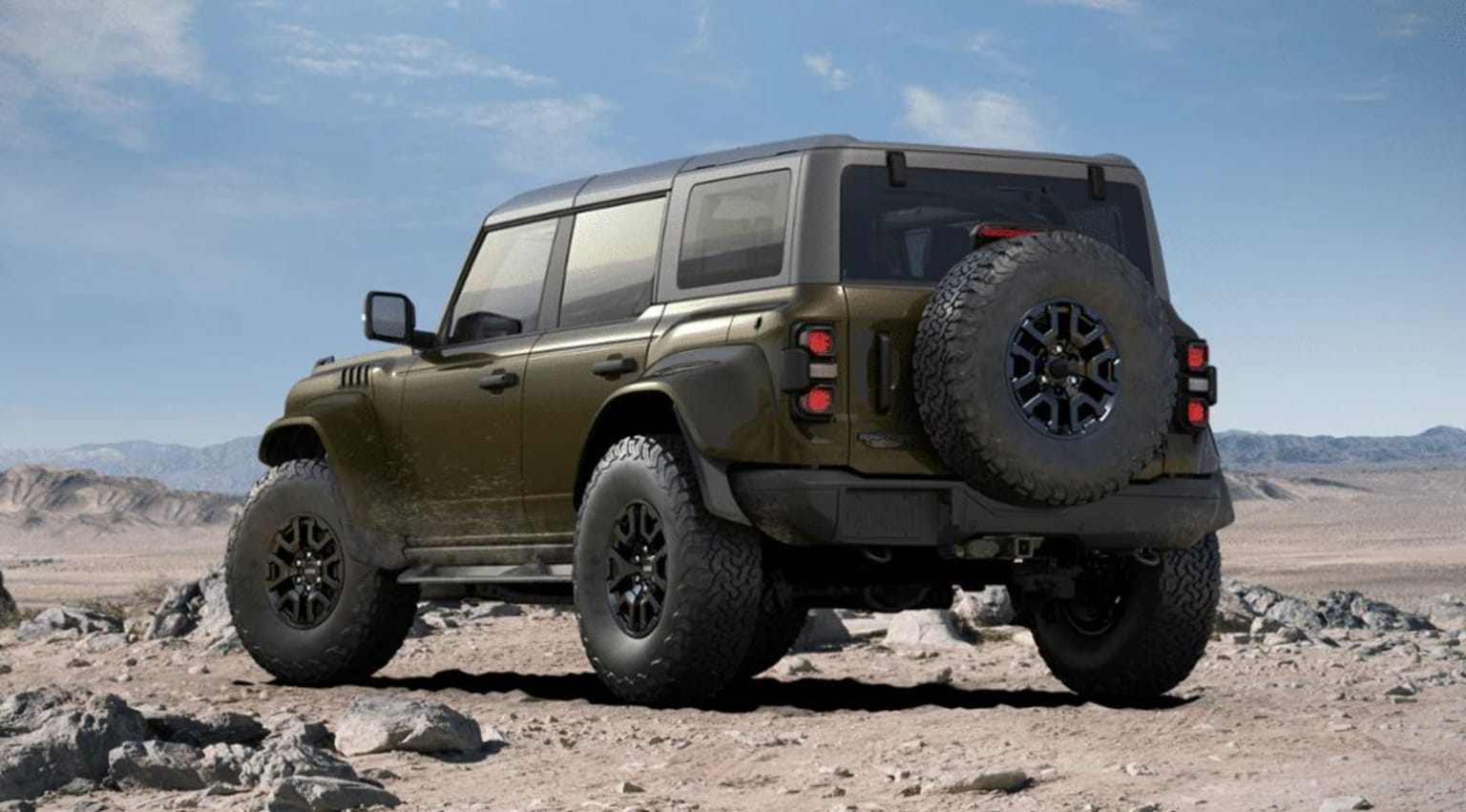 Off-road vehicle in desert landscape with large tires and sturdy frame.