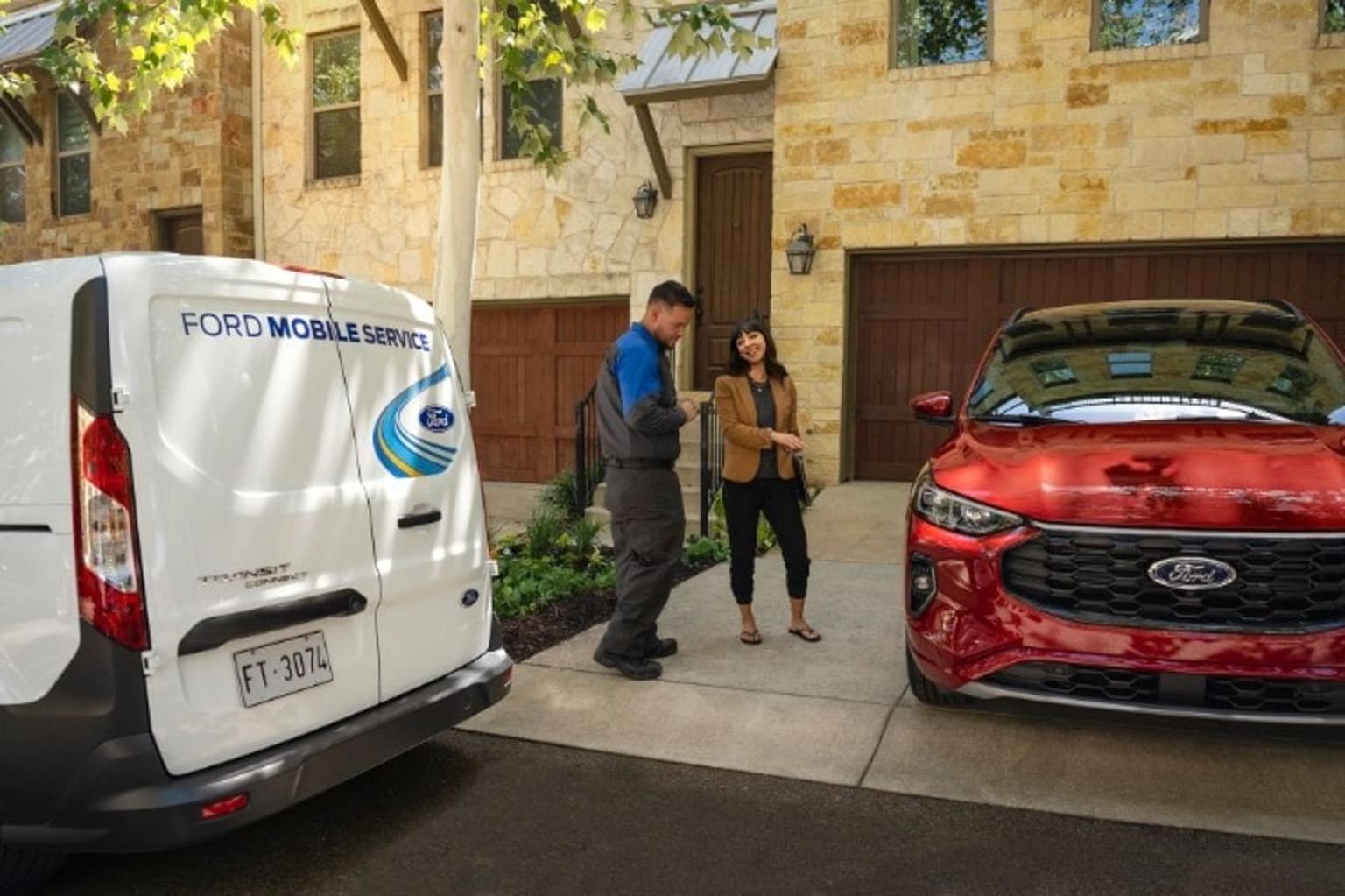 a couple of people standing in front of a red and white van parked in front of a brick building