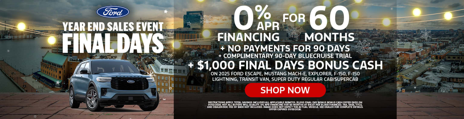 The image displays a Ford dealership advertisement featuring various vehicle models and promotional offers, including 0% financing for 60 months and a $1,000 final days bonus, set against a backdrop of a sunset sky with fireworks.