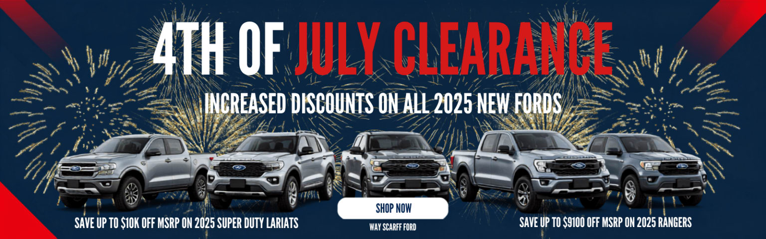 Five silver trucks are displayed in the foreground with a "4th of July Clearance" banner and fireworks in the background.