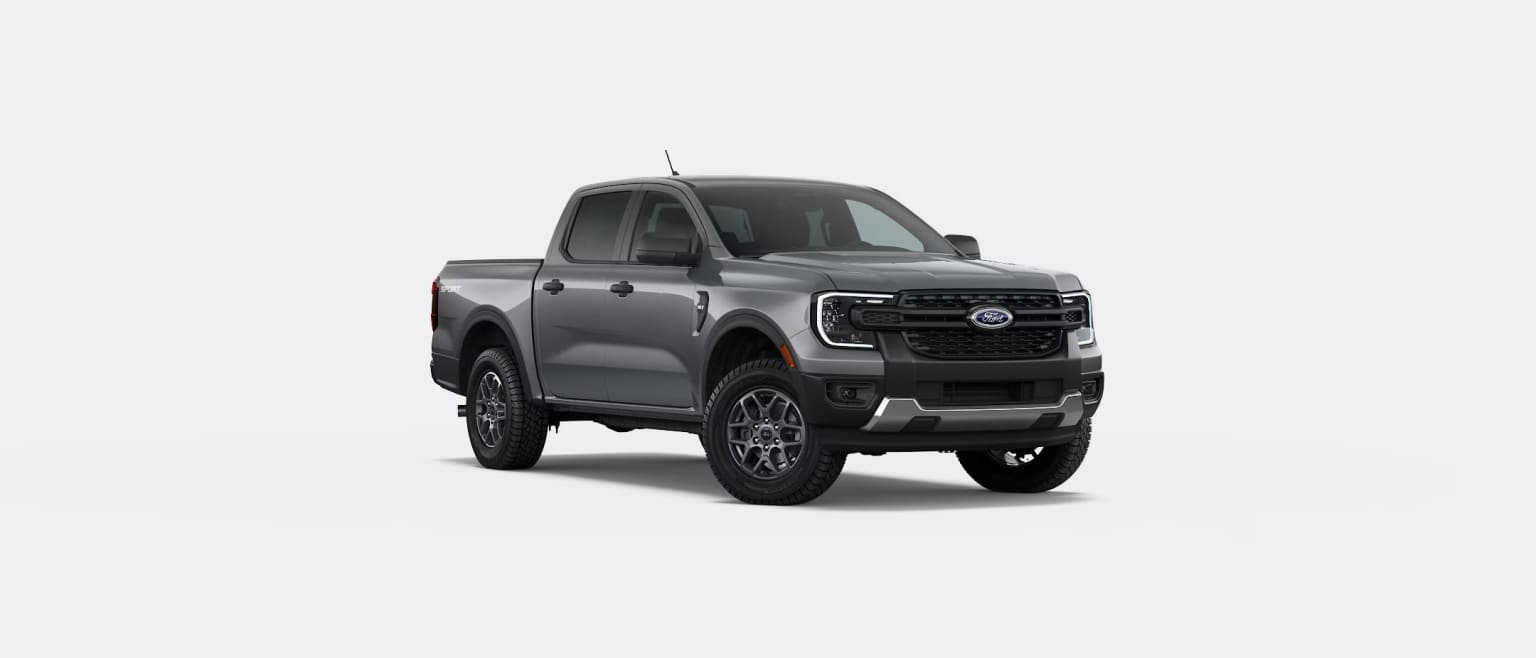 A rugged and imposing gray pickup truck with a bold, aggressive design stands prominently in the frame, set against a plain white background.