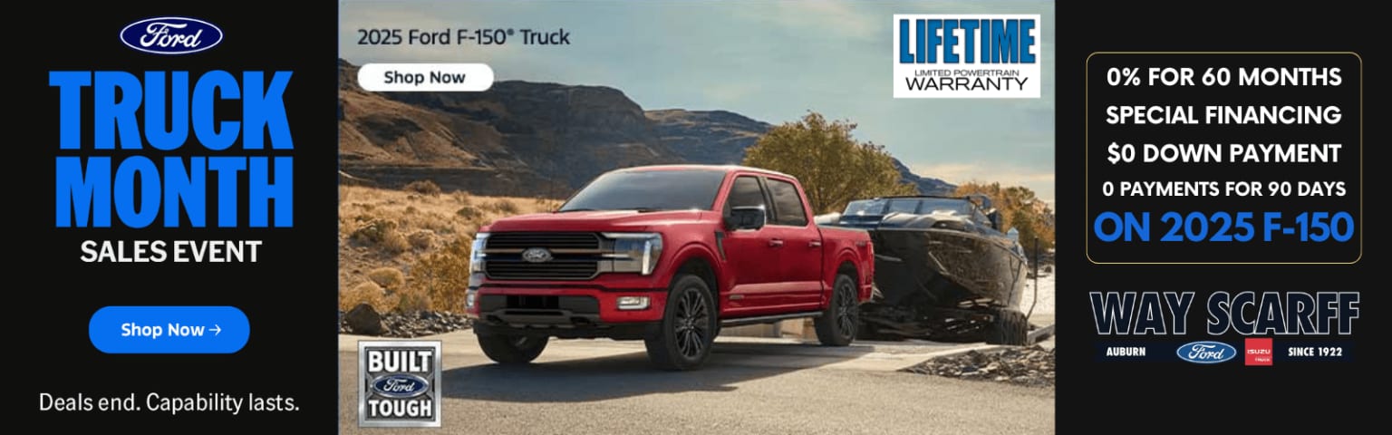 A red truck is shown in the foreground, parked on a dirt road surrounded by rugged, mountainous terrain in the background.