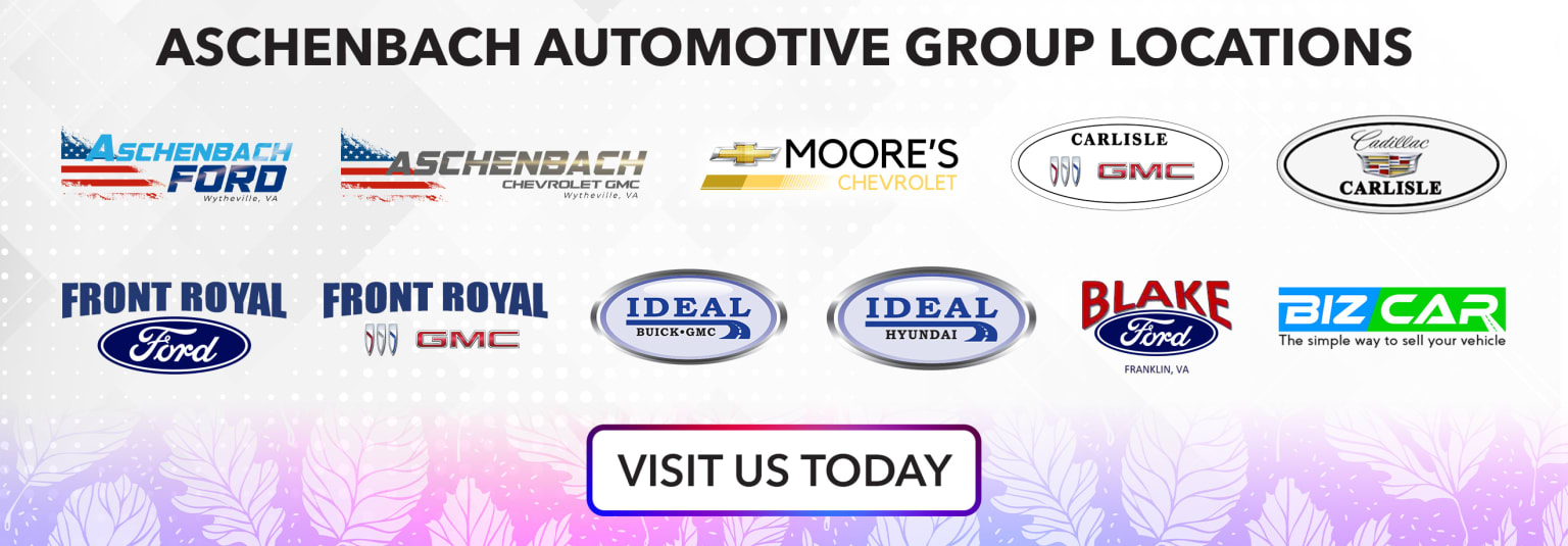 The image shows the signage and logos of various automotive dealerships, including Schenbach Automotive Group, Moore's Chevrolet, Carlisle GMC, Royal Front Royal GMC, Ideal Automotive, and Blake Ford. The background appears to be a plain white surface.