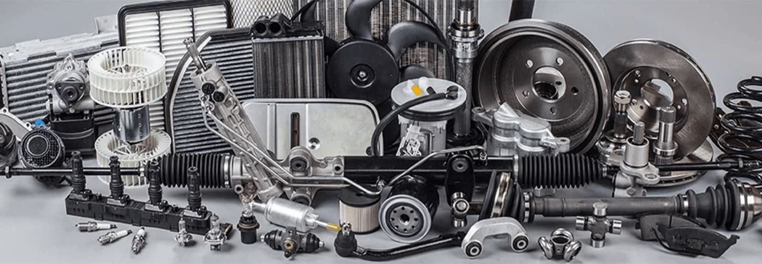 Various mechanical parts and components, including speakers, engines, and other automotive or industrial equipment, arranged in a cluttered and disorganized manner.
