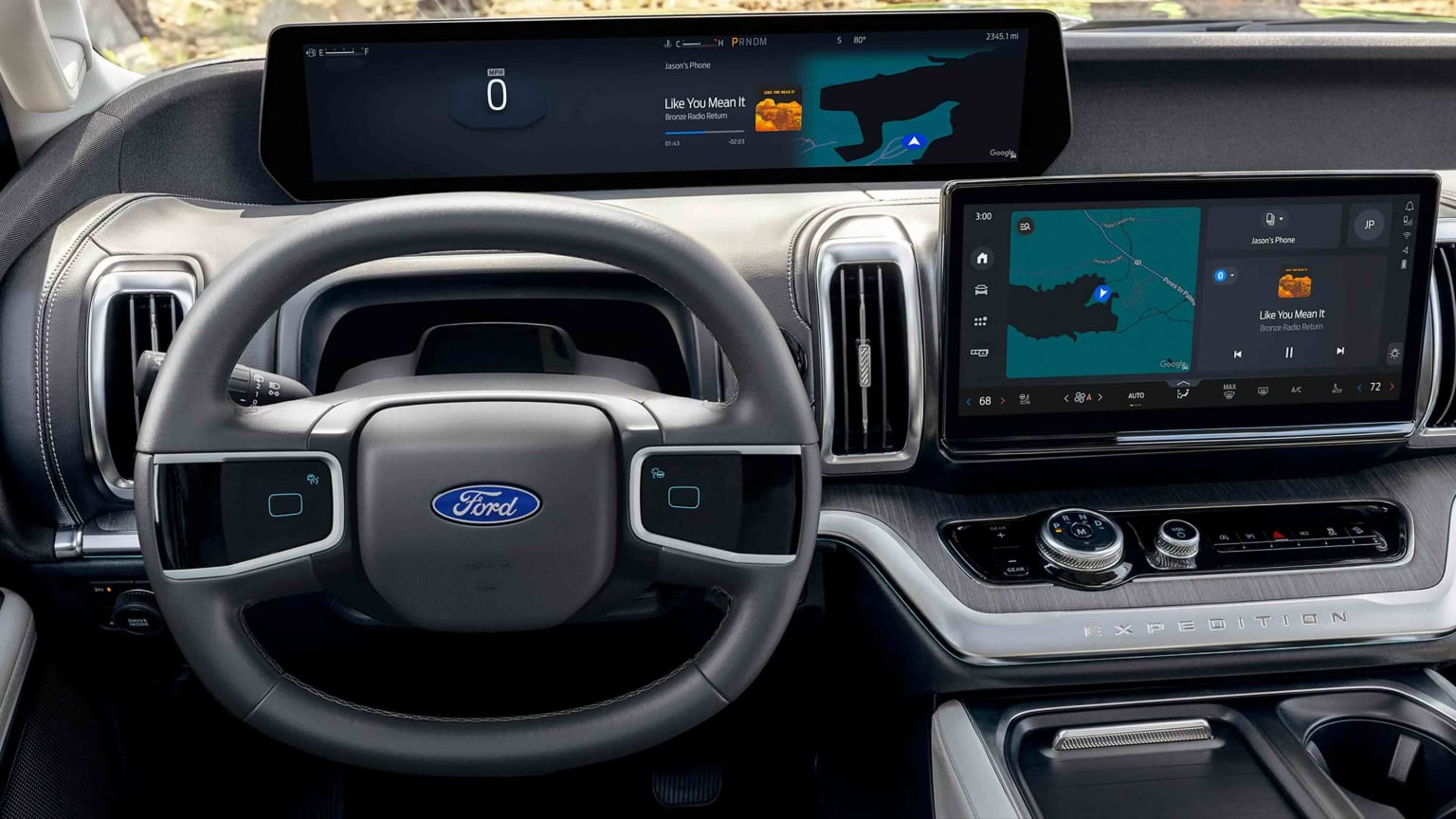 A modern car's dashboard featuring a large, integrated screen displaying navigation and vehicle information, with a steering wheel in the foreground and a blurred outdoor scene in the background.
