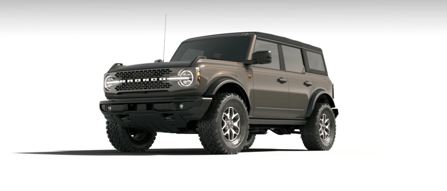 An off-road vehicle with a boxy, military-inspired design, standing on large, knobby tires against a plain background.