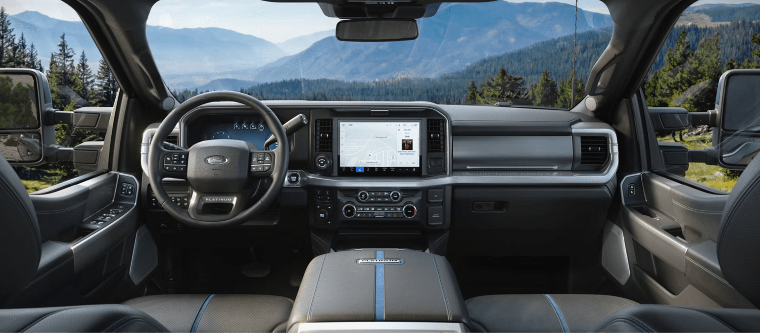 Modern interior of a truck with a scenic mountain view through the windshield.
