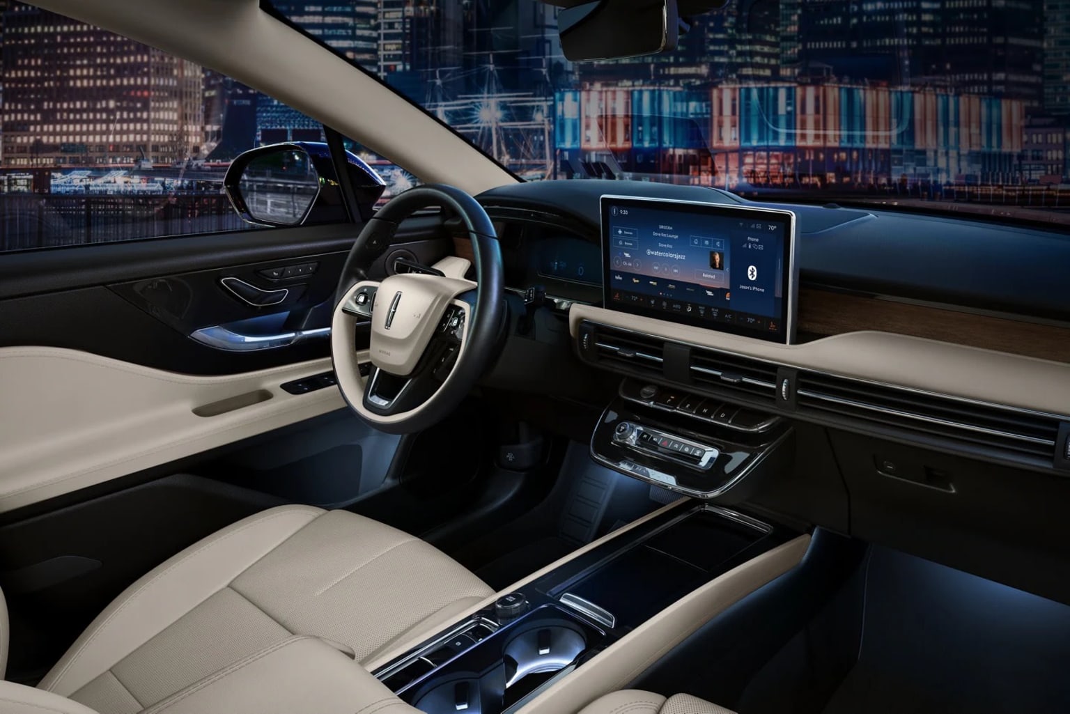 The image shows the interior of a modern, high-tech vehicle with a sleek dashboard, a large touchscreen display, and a cityscape visible through the windshield in the background.