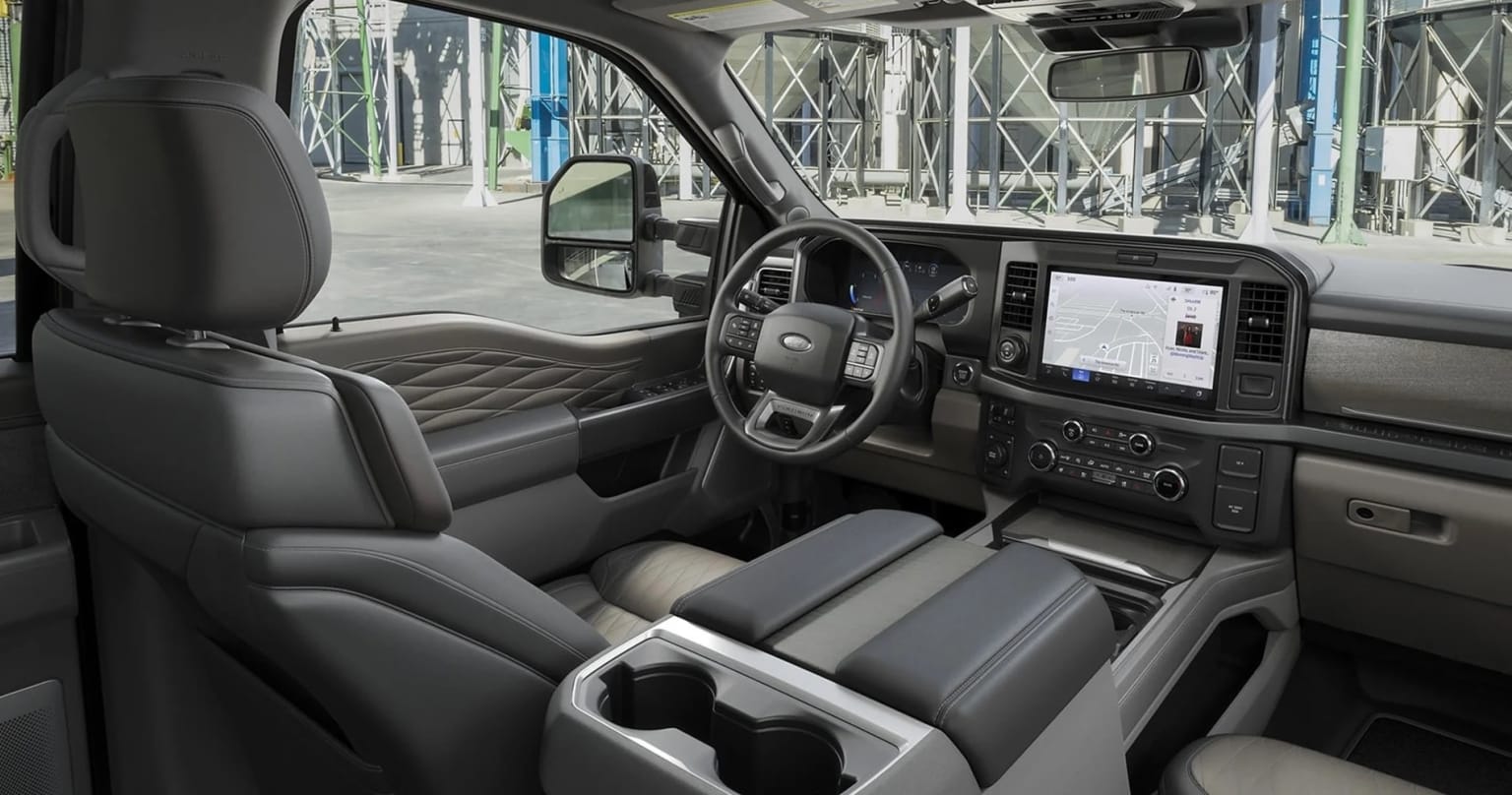 Interior of a modern van or truck with a spacious and well-equipped cabin, including a dashboard, steering wheel, and various controls and displays.