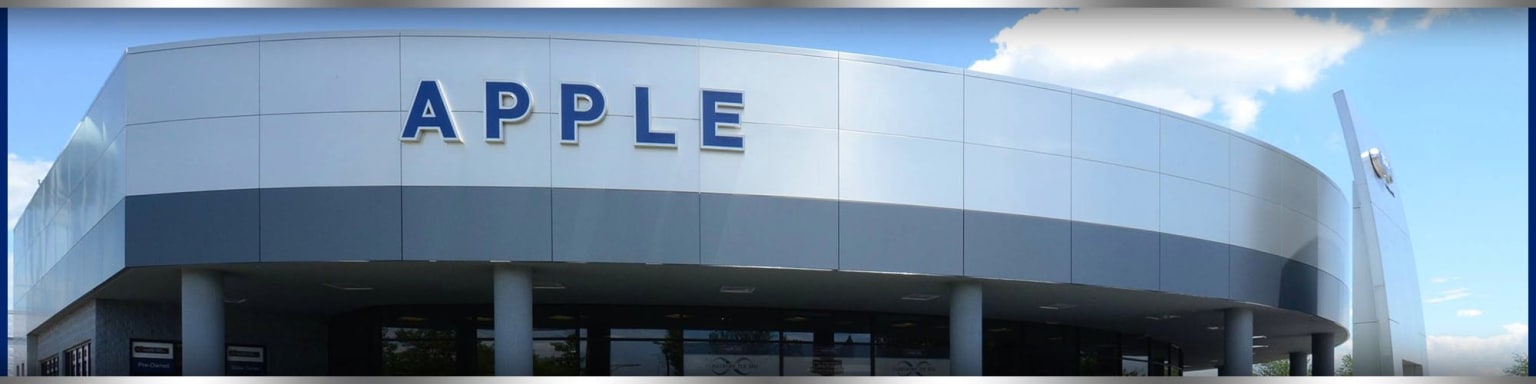 a building with a sign that says apple on the side of it's front door and the words apple on the side of the building