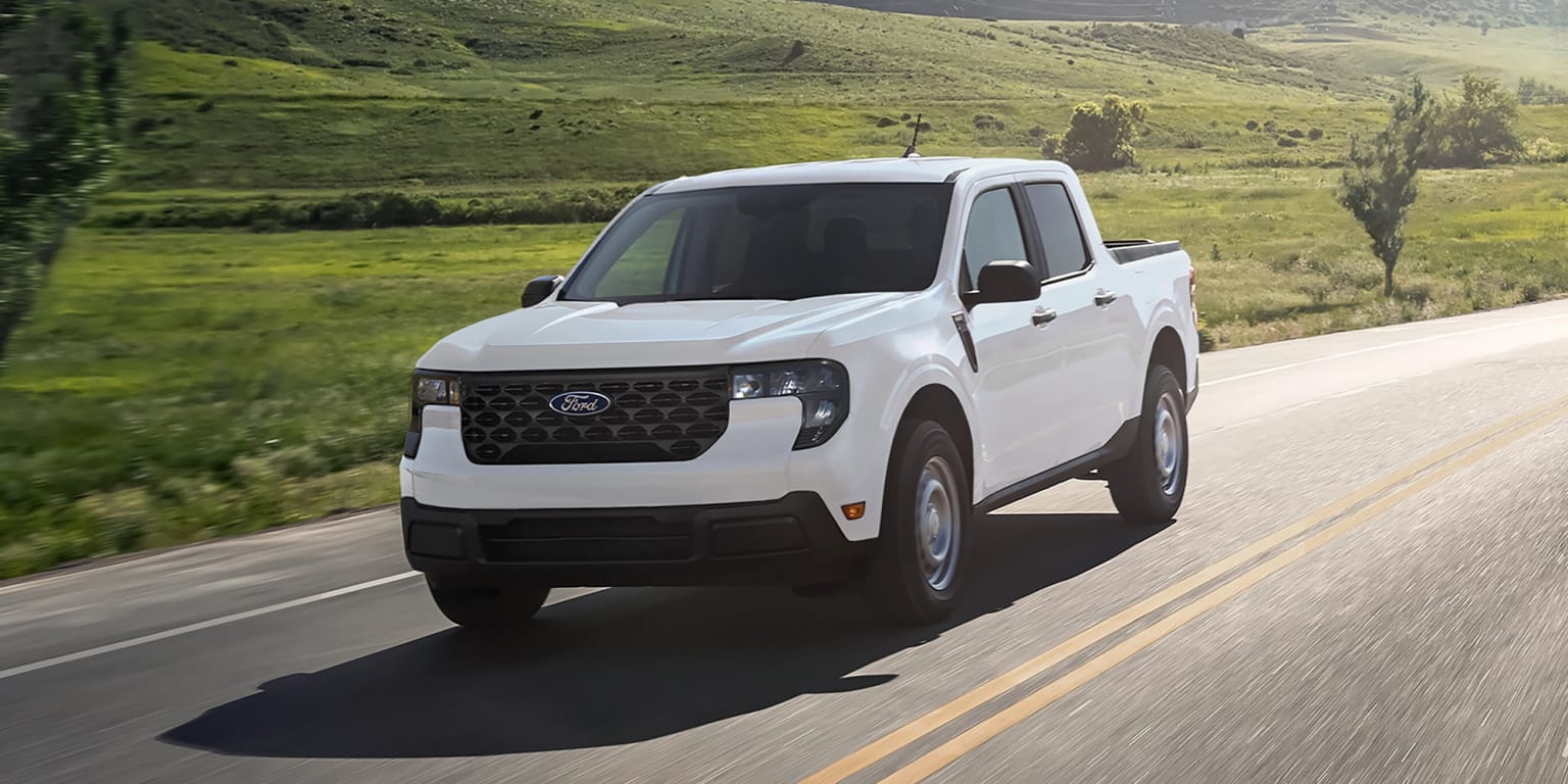 A pickup truck on a countryside road.