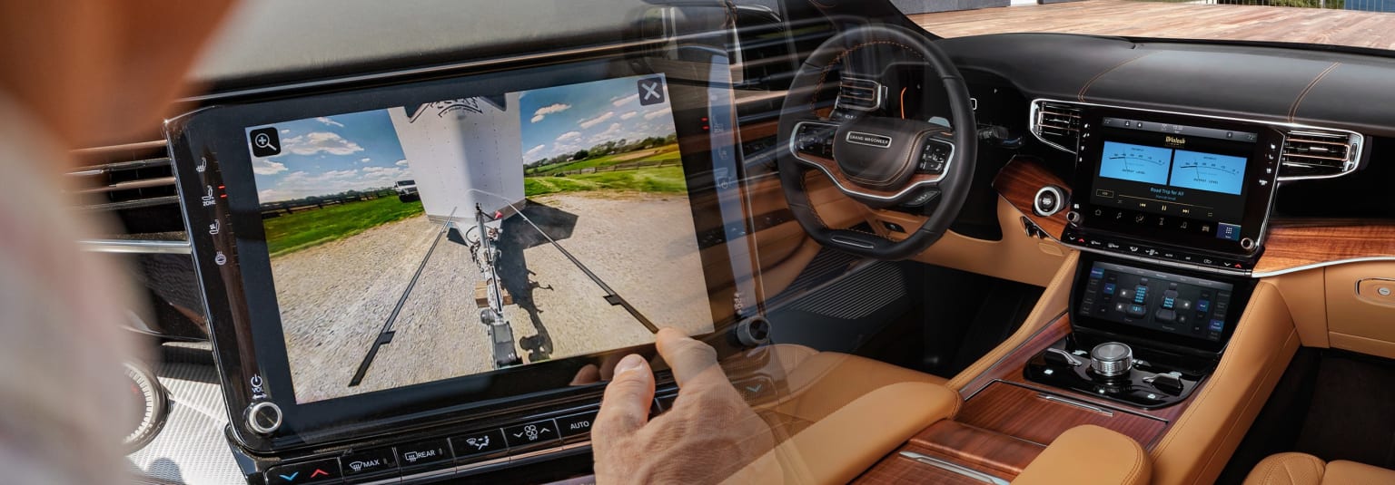 a man is driving a car with a large screen on the dash of the car and a camera attached to the front of the car