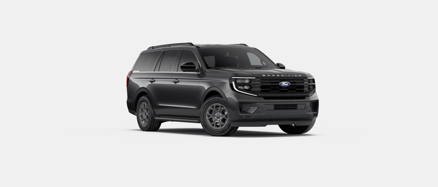 A dark grey SUV is centered in the foreground against a plain, solid white background.