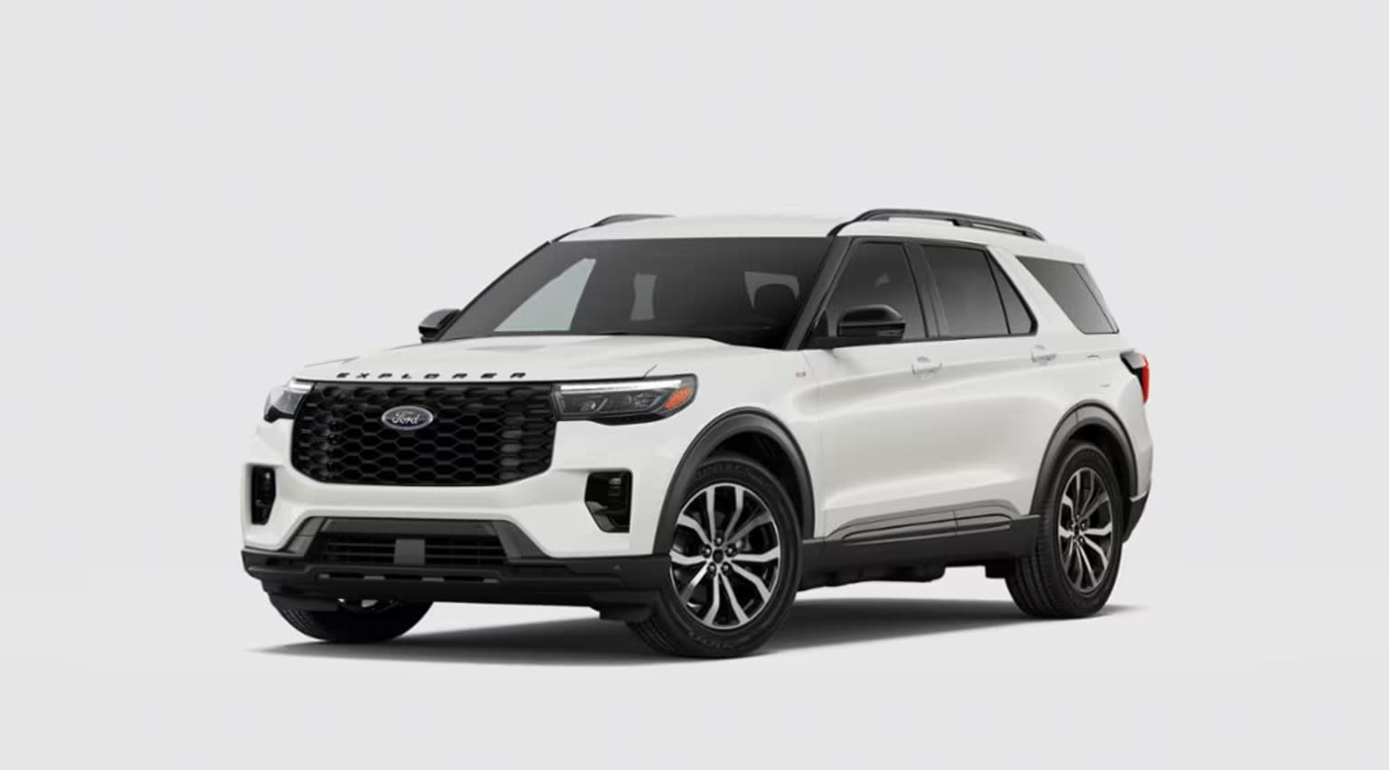 A white SUV with a bold, angular design and distinctive grille stands prominently against a plain background.