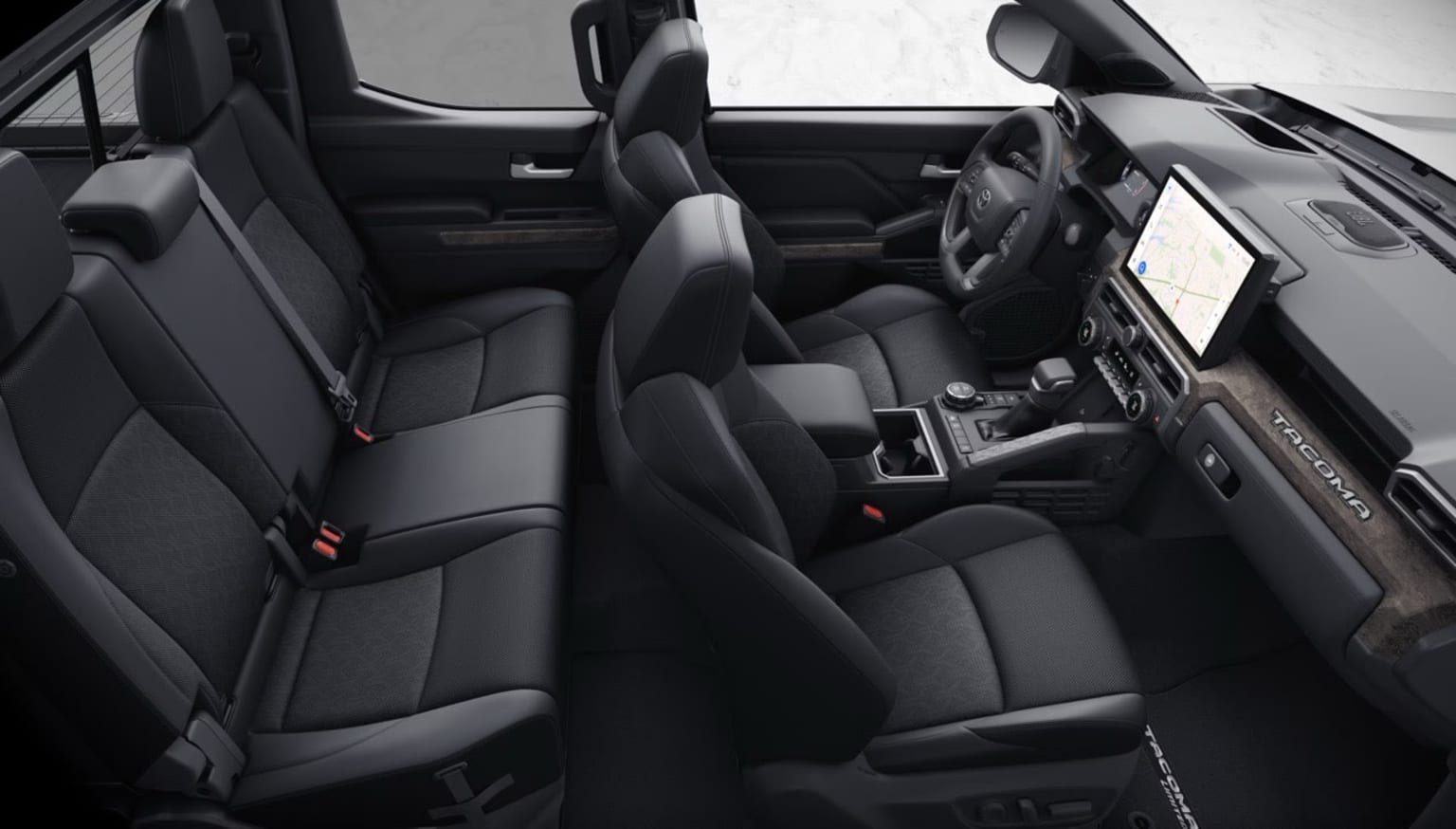 Interior of a vehicle with black leather seats and various controls and displays visible.