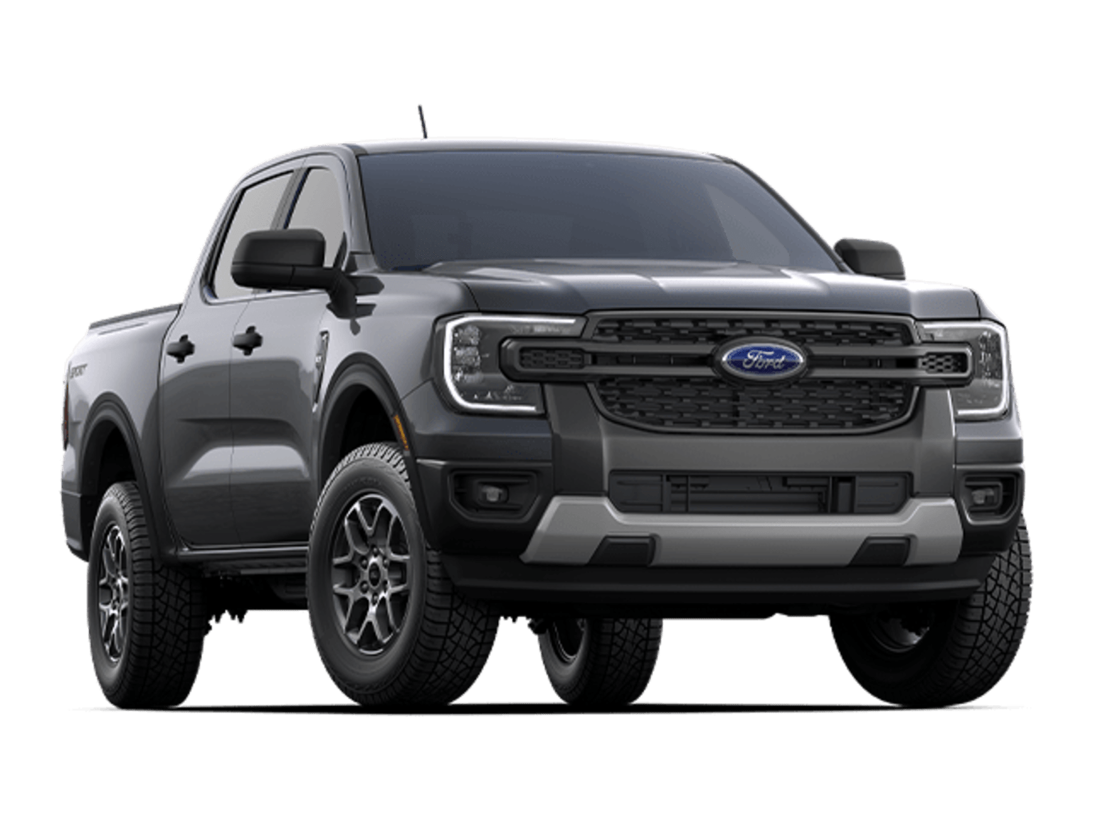 A dark-colored pickup truck with a rugged, off-road appearance, featuring large tires and a prominent grille, stands against a plain white background.