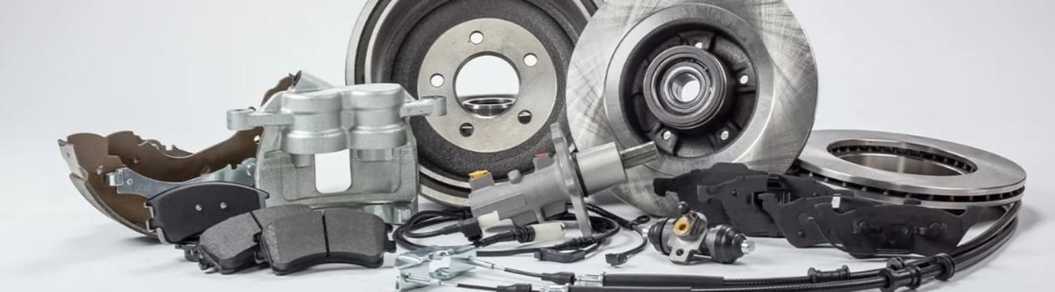 Various automotive parts, including brake discs, calipers, and other components, arranged in a detailed and organized manner, suggesting a focus on automotive repair or maintenance.
