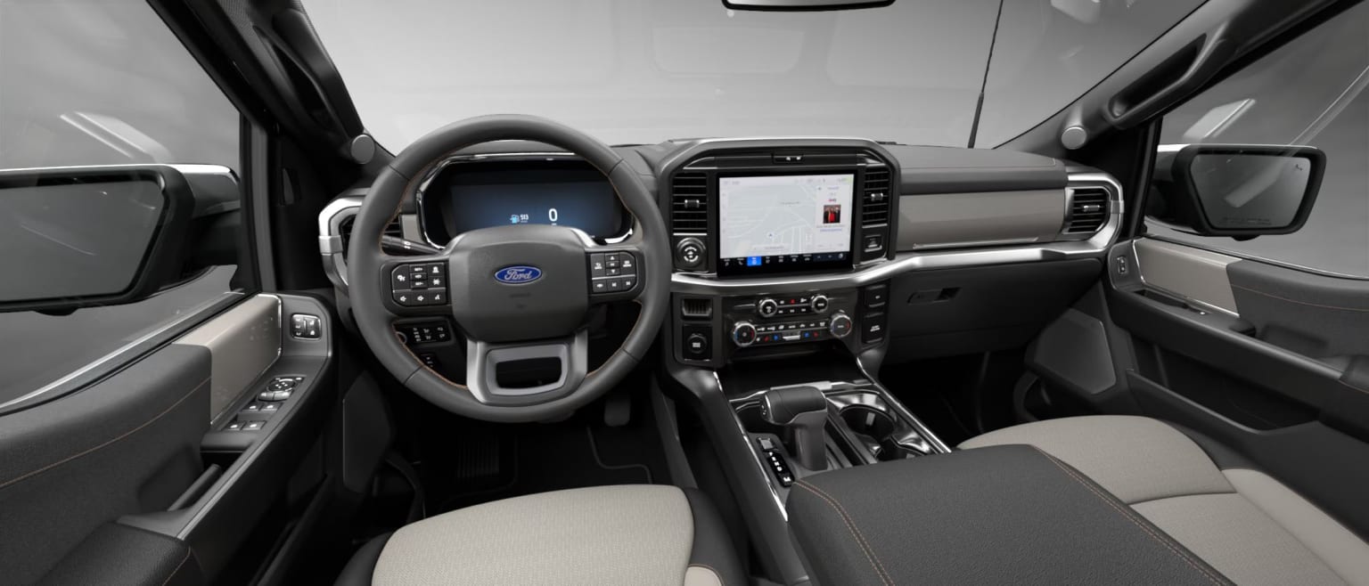 Interior of a modern vehicle featuring a steering wheel, dashboard, and various controls and displays. Clean and minimalist design.