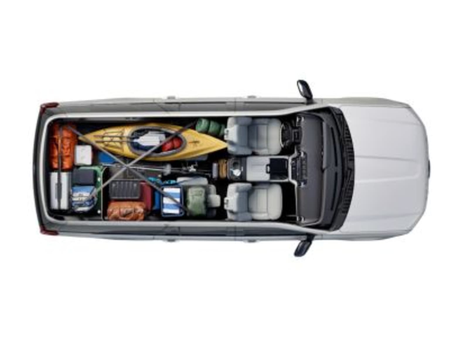 Cargo area of a van filled with various tools, equipment, and supplies, indicating its work or transportation utility.