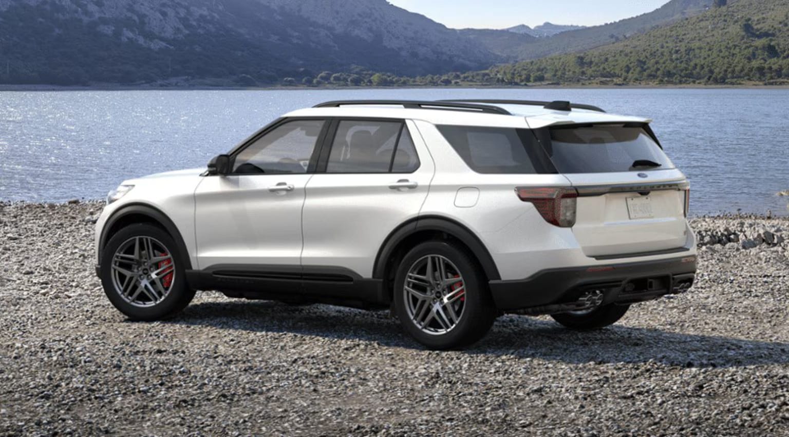2025 Ford Explorer Exterior Color Option Star White Metallic Tri-Coat parked on rocky shore with lake and mountains in background.