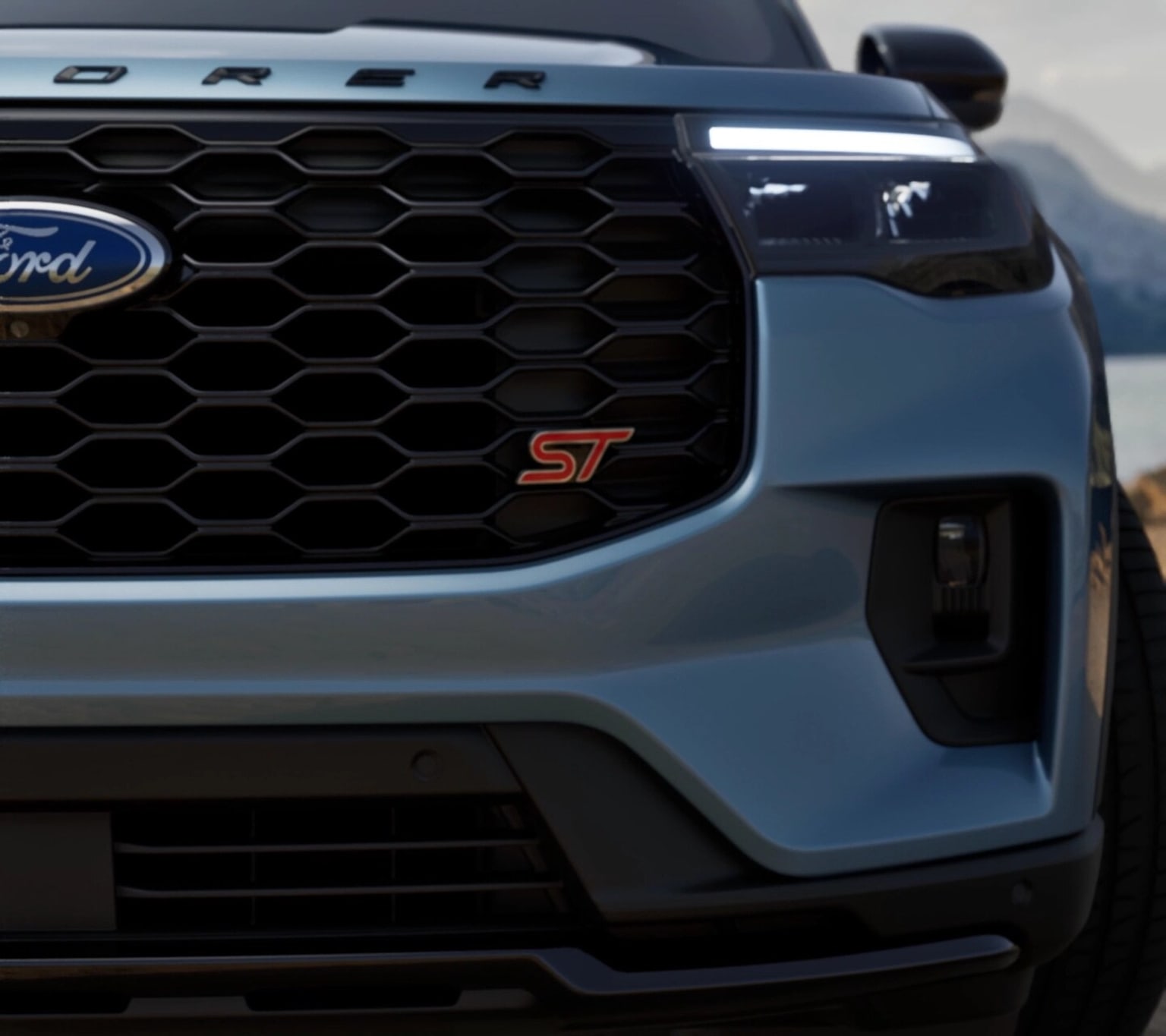 The image shows the front grille and headlight of a pickup truck, with the "ST" badge prominently displayed on the grille.