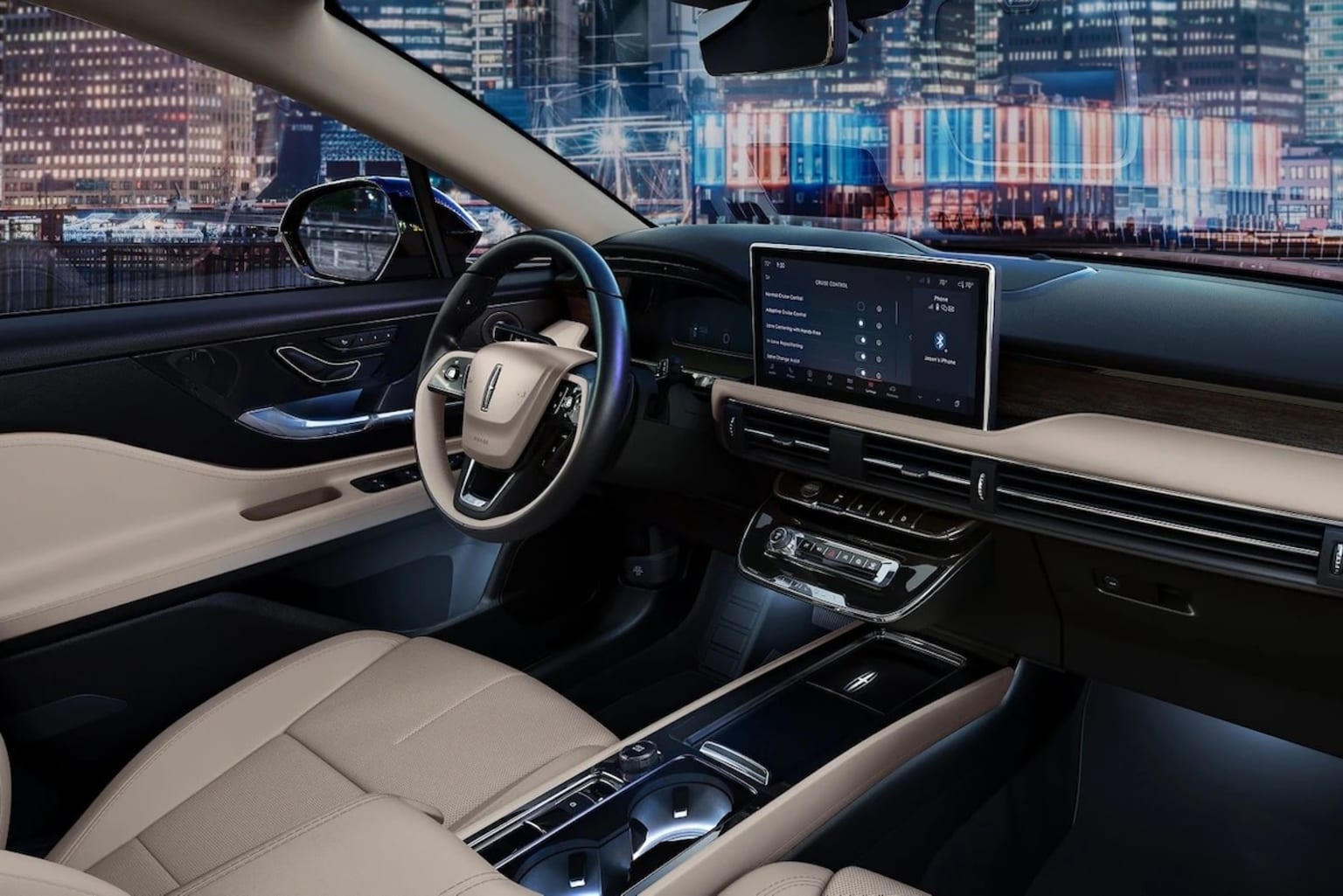 2025 Lincoln Corsair smoked truffle interior view parked in a city with bright lights in the windshield