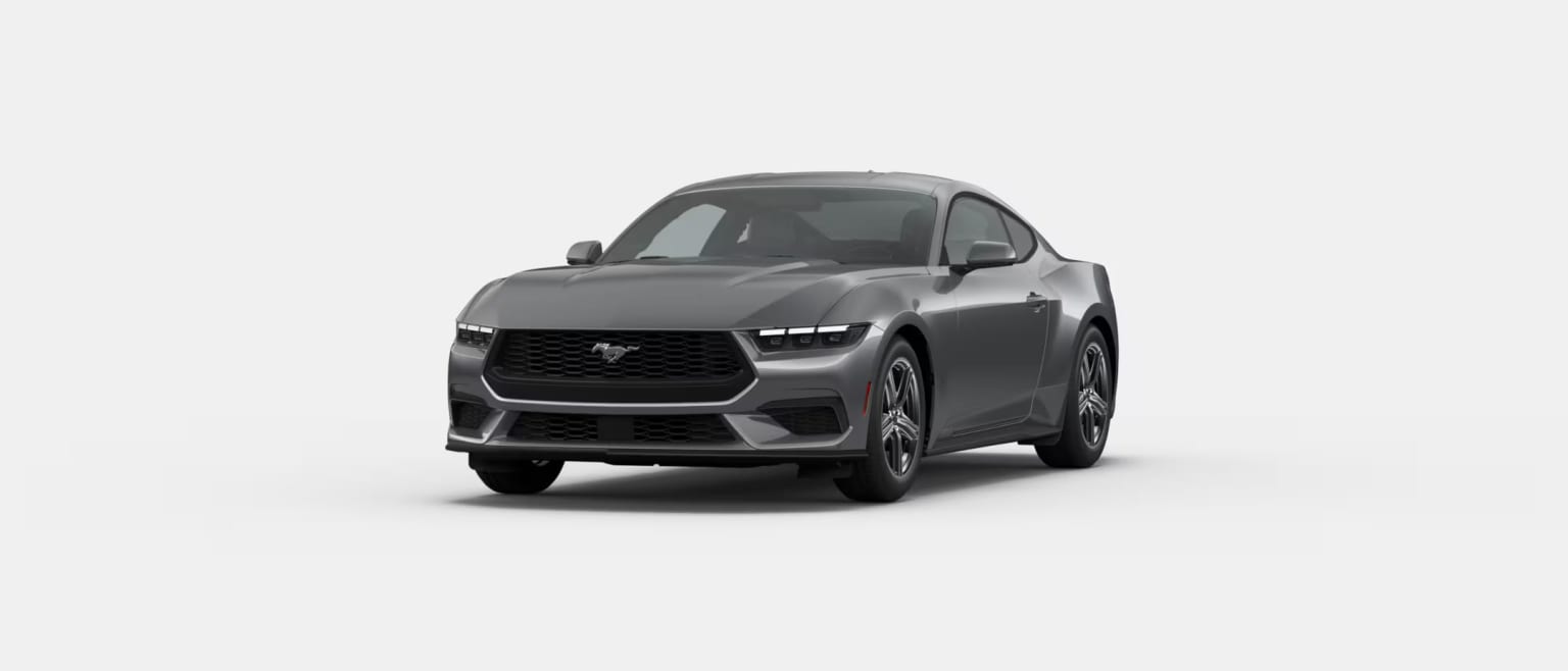 A sleek, gray SUV with a bold, angular design stands prominently in the frame, its sharp lines and aggressive styling commanding attention.