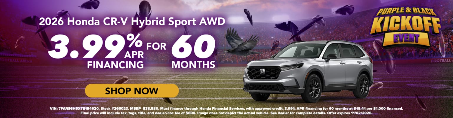 A silver SUV parked on a football field with a stadium background and purple lighting.