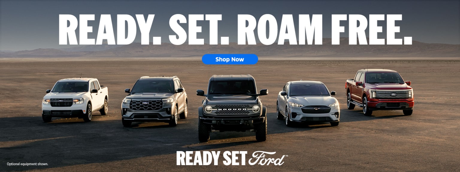 A lineup of various vehicles including SUVs and trucks against a desert landscape with the text "READY.SET.ROAM FREE" prominently displayed above.
