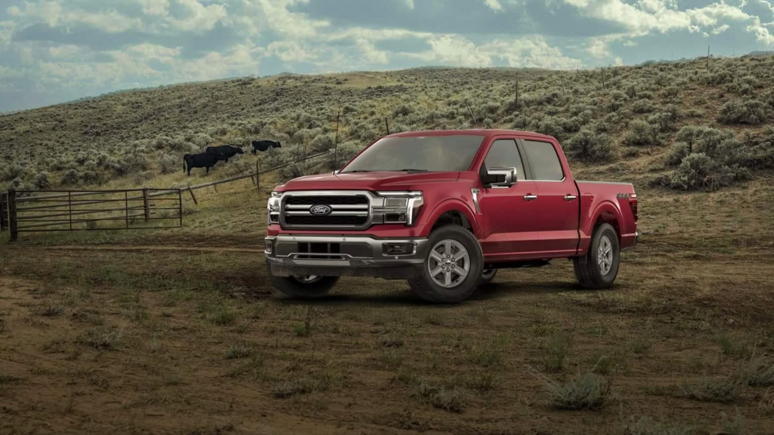A red pickup truck is parked in a dry, grassy field with cattle grazing on a rolling hill in the background under a cloudy sky.