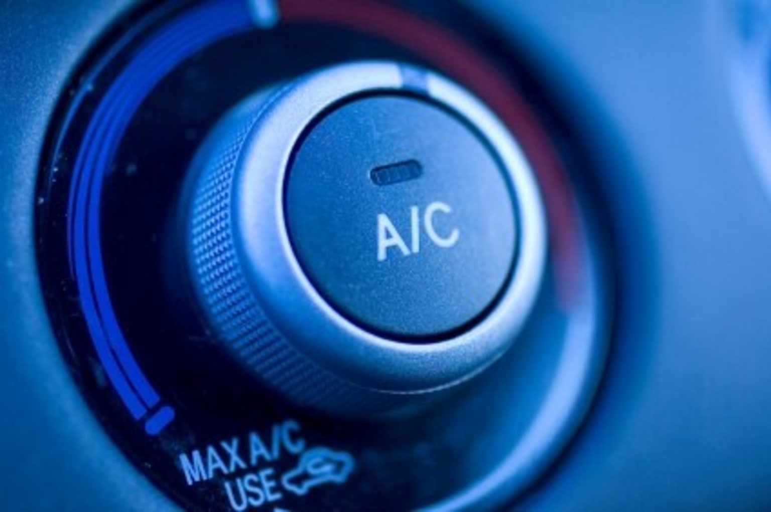 a close up view of a button on a car's gear levers with the word aic written on it