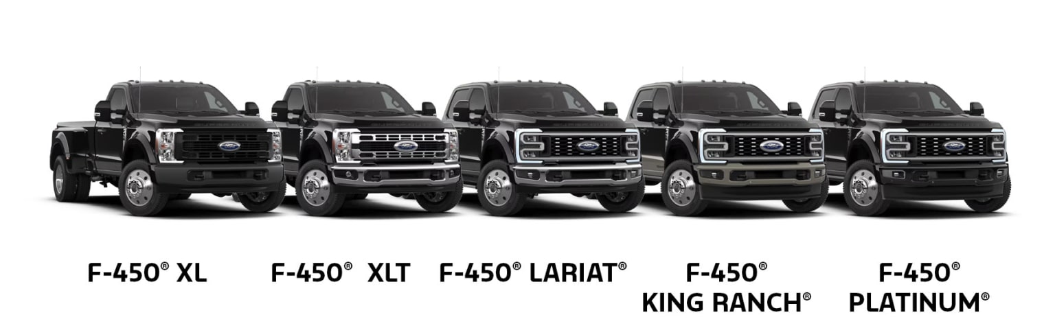 Three large black pickup trucks showcasing three different models, all prominently featured against a plain white background.