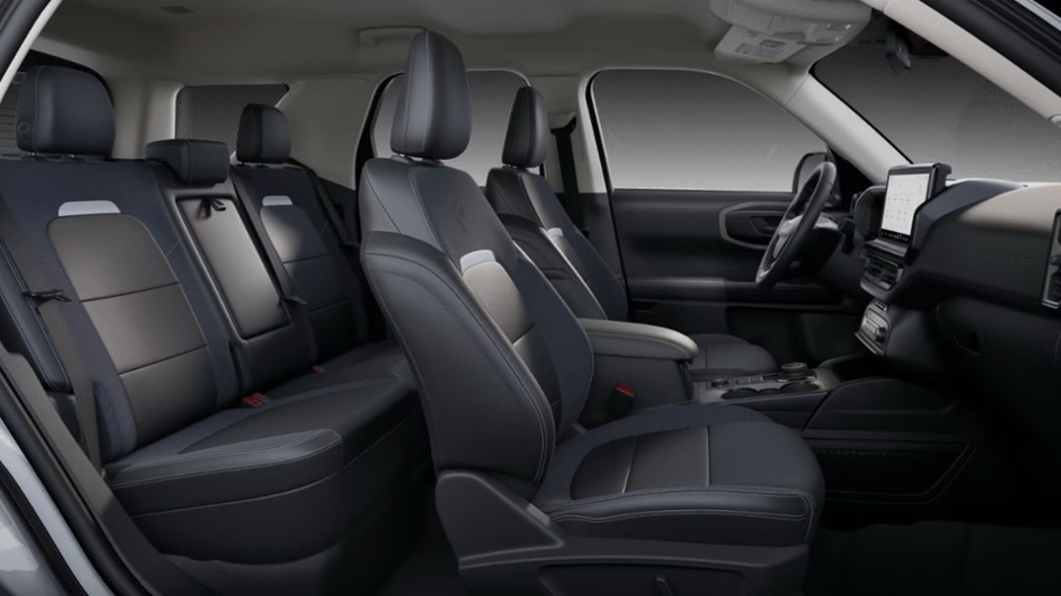 The image shows the interior of a vehicle, with multiple rows of gray and black leather seats visible. The seats appear to be well-designed and comfortable, with headrests and armrests visible. The background of the image is dark, suggesting a dimly lit or enclosed space.