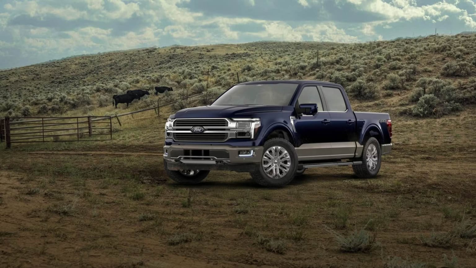 A dark blue pickup truck is parked on a dirt road in the foreground, with rolling hills and a herd of cattle in the background under a cloudy sky.