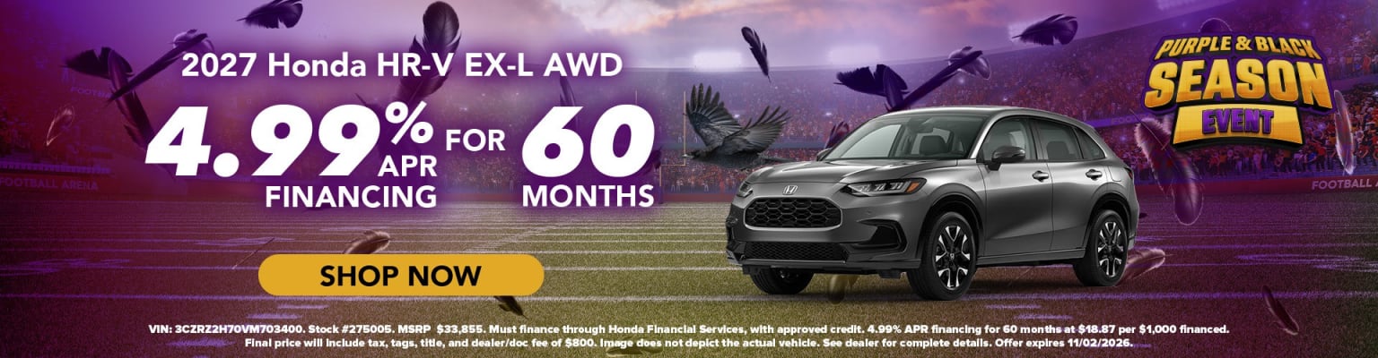 A grey SUV is parked in front of a football stadium backdrop with flying purple and black feathers and financing information.
