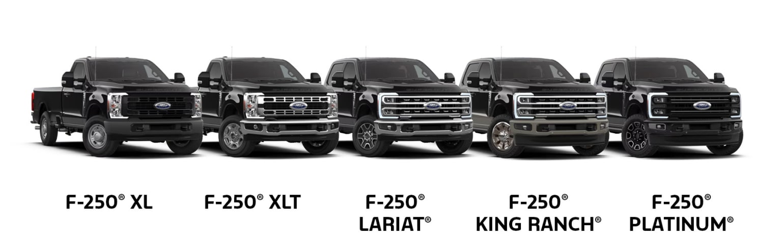 A row of three pickup trucks in various trim levels, including XLT, Lariat, and King Ranch models, against a plain white background.