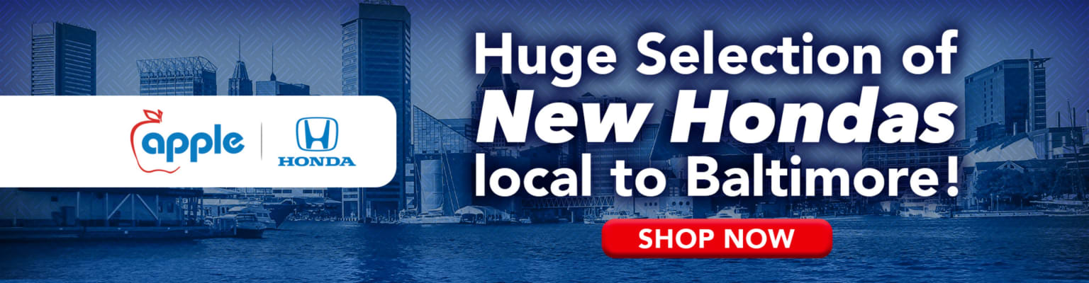 A white banner with logos is in the foreground, while the background features a blue-toned cityscape with the text "Huge Selection of New Vehicles local to Baltimore!" and a "Shop Now" button.