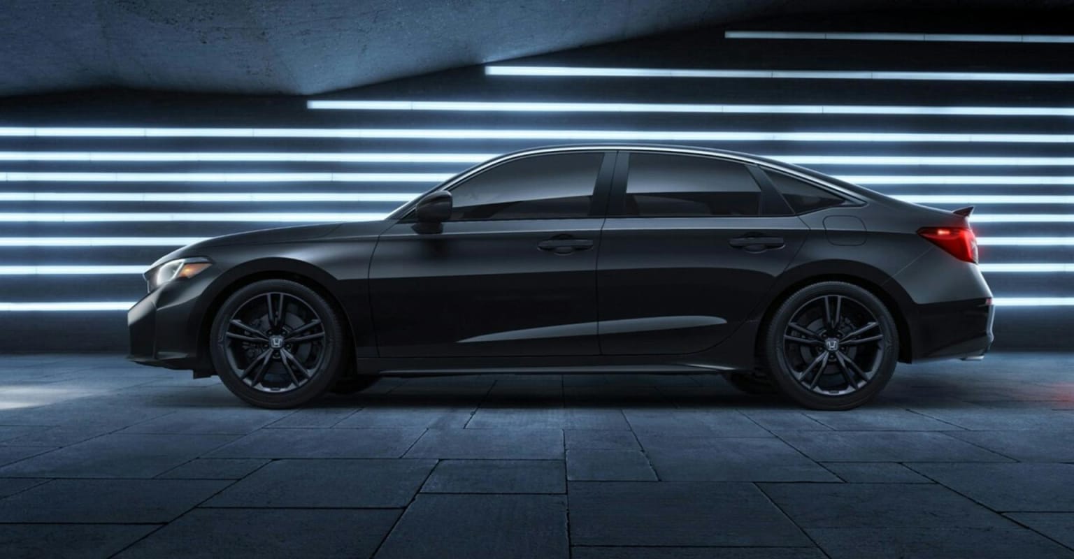A black sedan parked on textured floor with illuminated horizontal lines in the background.