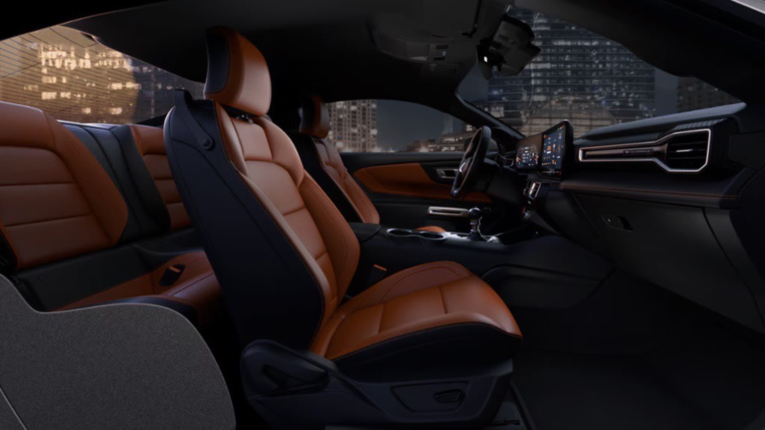 The image displays the interior of a car at night, showing the city skyline through the windshield in the background.