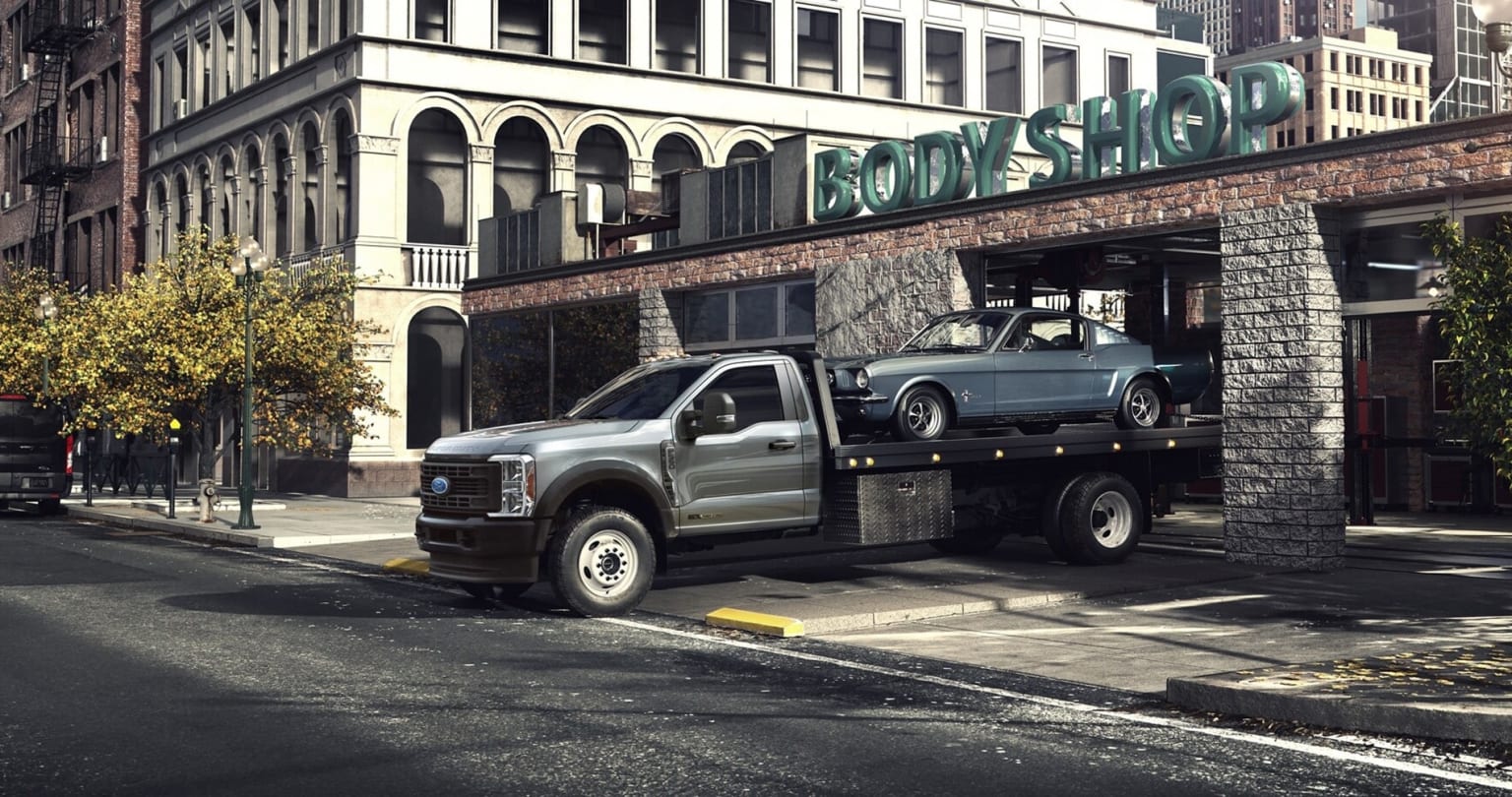 Ford cab & chassis for sale with a flatbed on it and a classic Ford Mustang