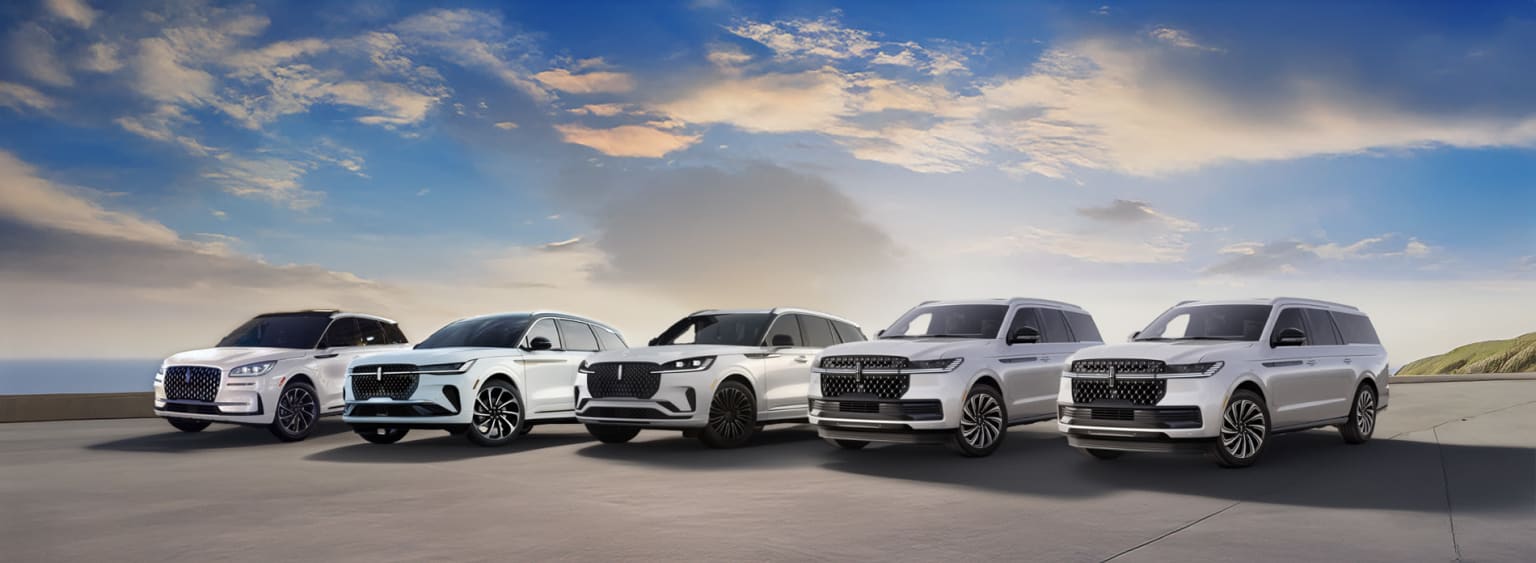 A row of Lincoln SUV models by Size Parked on an Ocean Overlook