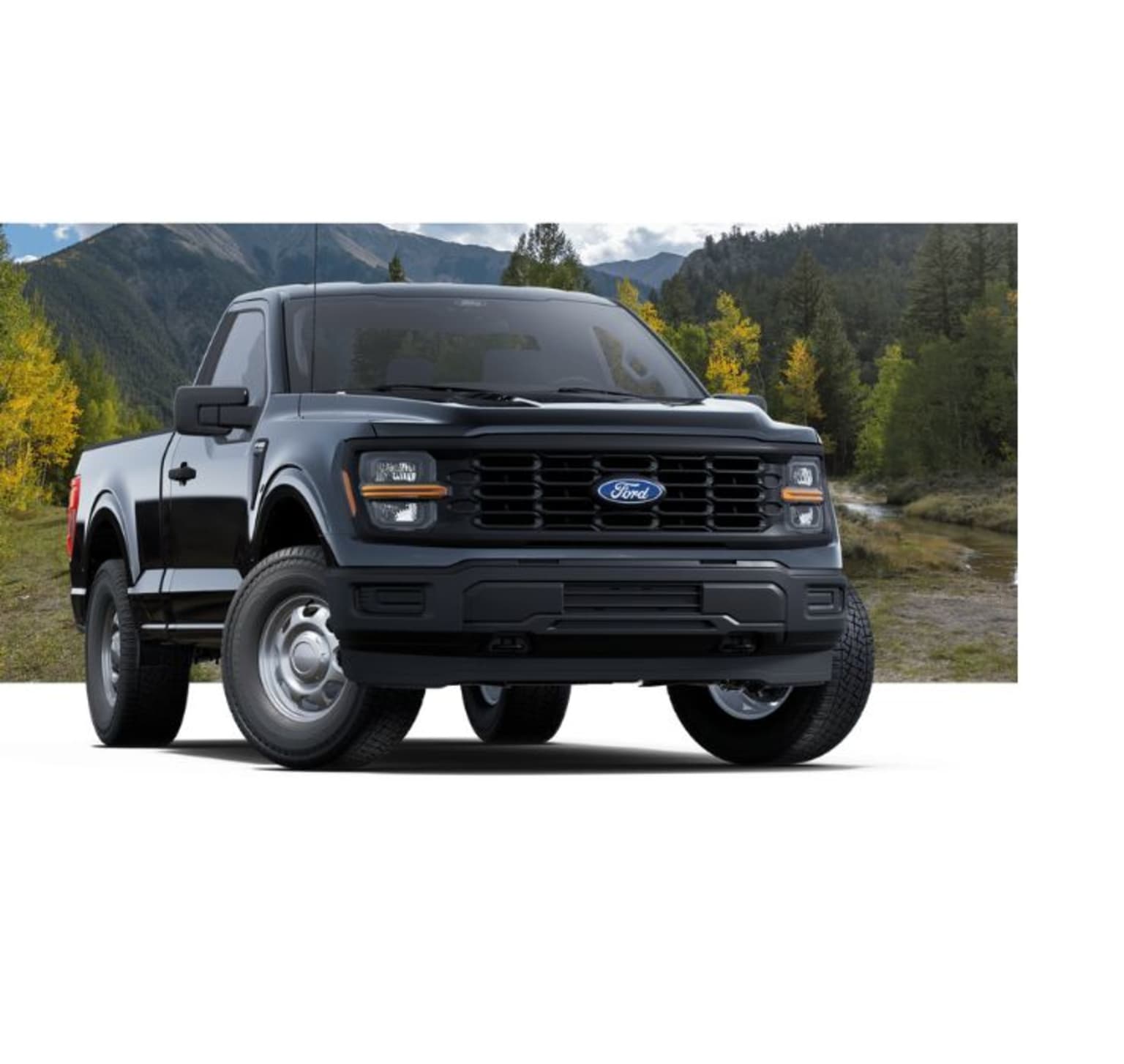 A rugged black pickup truck stands in the foreground, surrounded by a picturesque mountain landscape with vibrant fall foliage in the background.