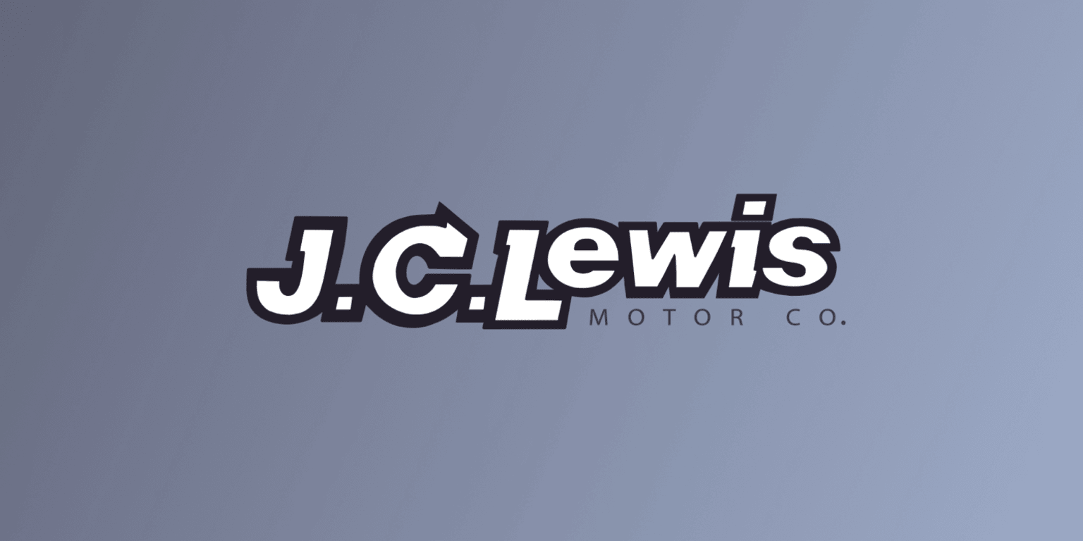 the j c lewis motor co logo on a gray background with a black and white stripe across the bottom of the logo