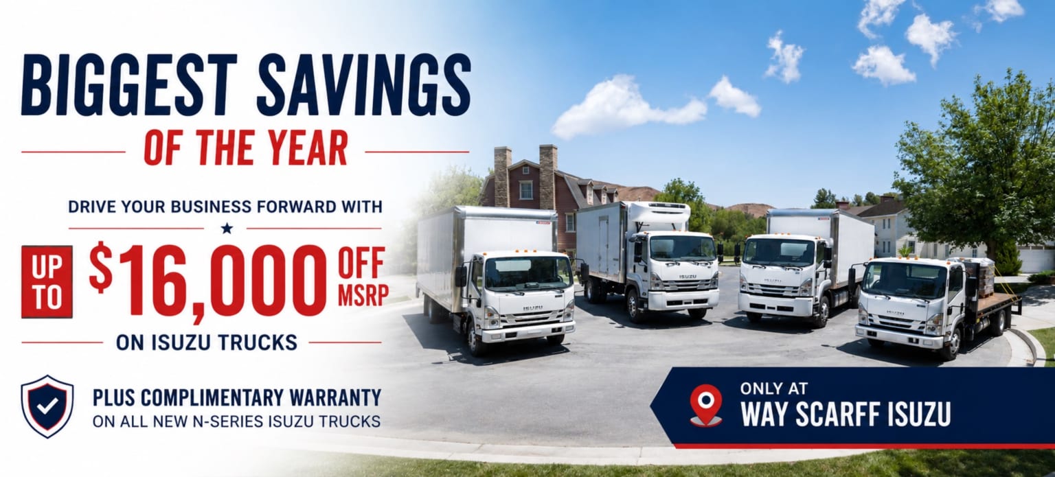 A group of white trucks parked in front of houses under a blue sky with clouds, while text on the left advertises "Biggest Savings of the Year" and a "Complimentary Warranty."