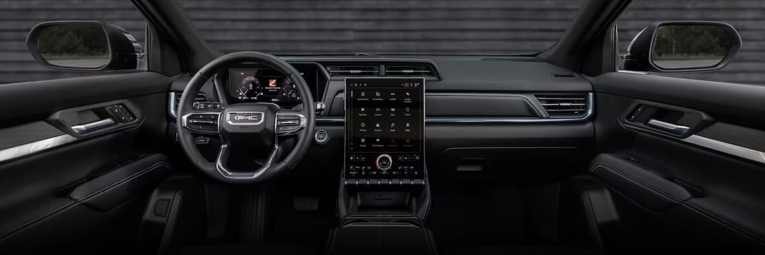 Image of a modern vehicle interior with a sleek and minimalist dashboard design, touchscreen display, controls, and steering wheel.